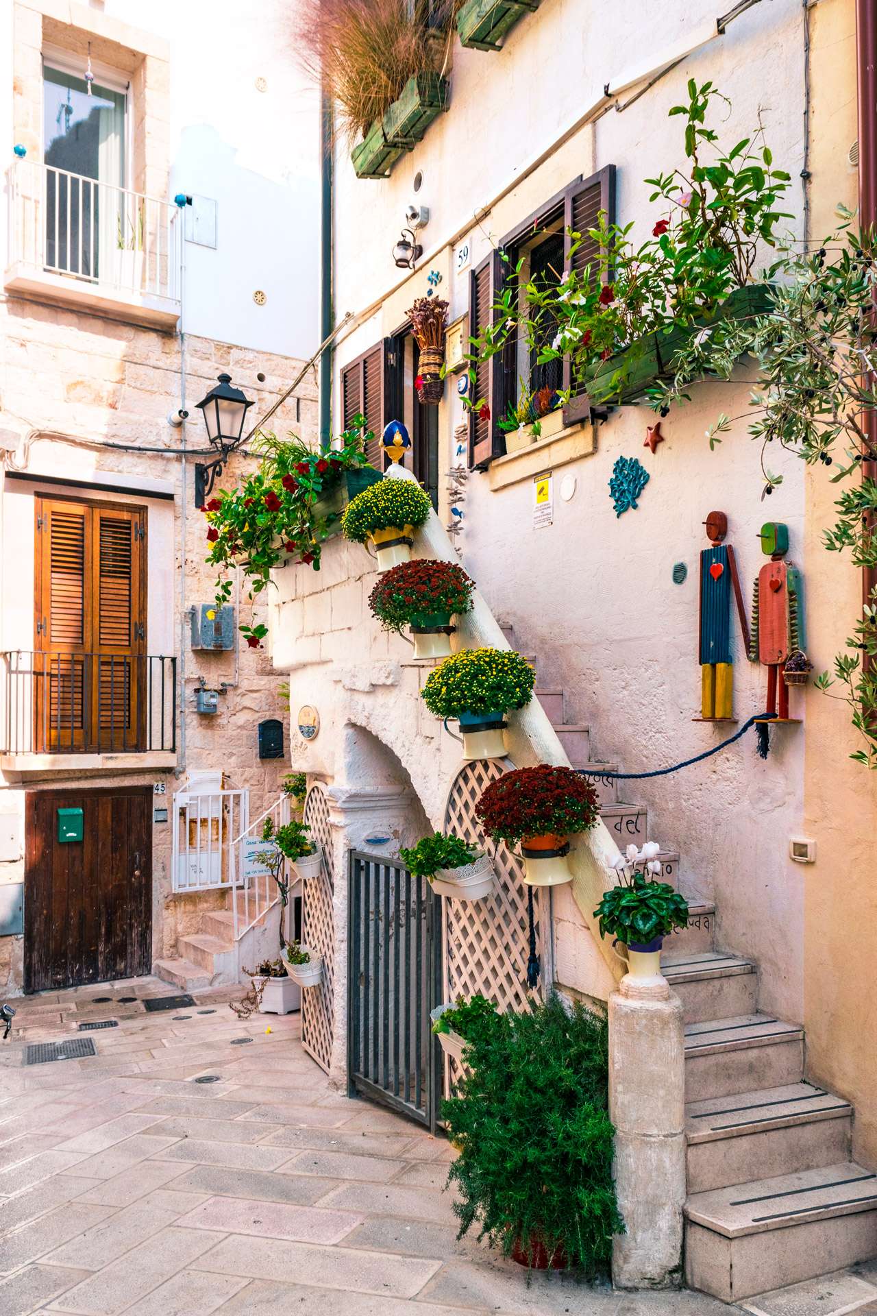 A colorful flowered street at Polignano a Mare | Cala Monachile | Puglia