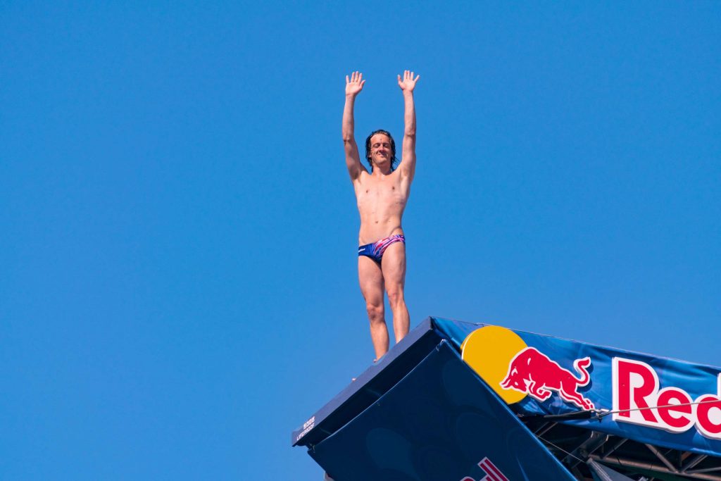 A diver of the Red Bull Cliff Diving competition at Cala Monachile | Polignano a Mare | Puglia