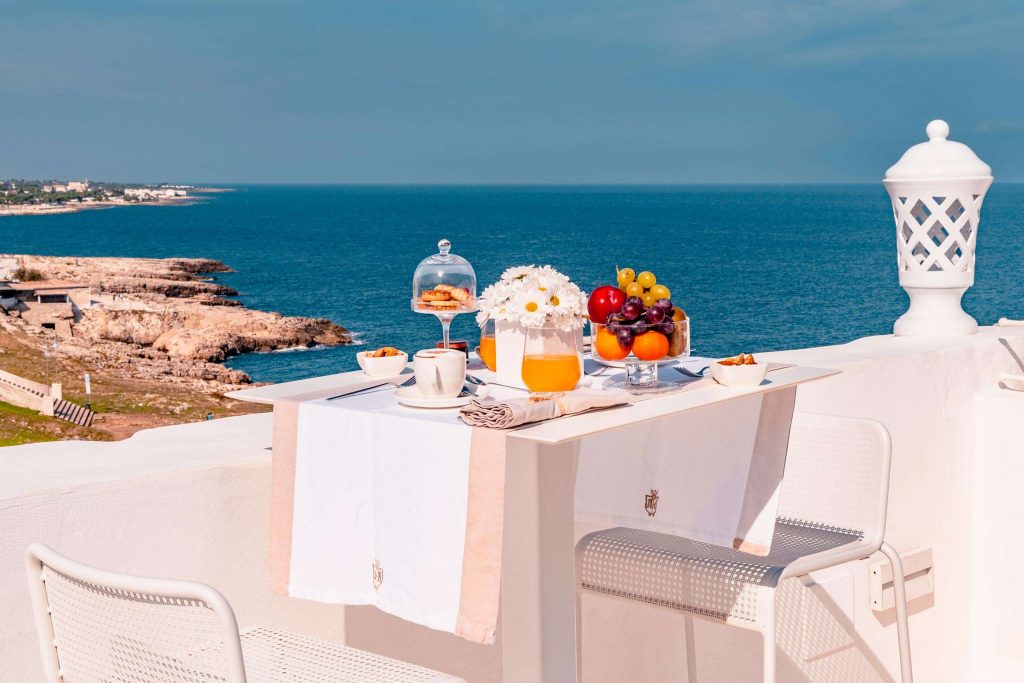 Breakfast served on the terrace which overlooks the sea at San Michele Suite with its luxury suites in Polignano a Mare